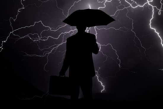 business man carryin a breifcase during a lighting storm
